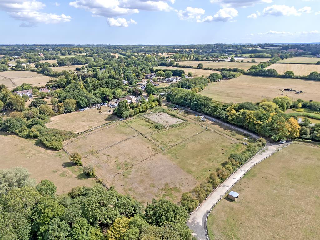 Lot: 72 - VACANT LAND IN VILLAGE LOCATION - Aerial drone shot of the land